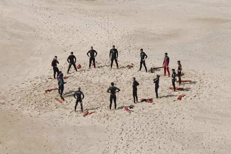 Colleagues doing their annual team building by the beach.